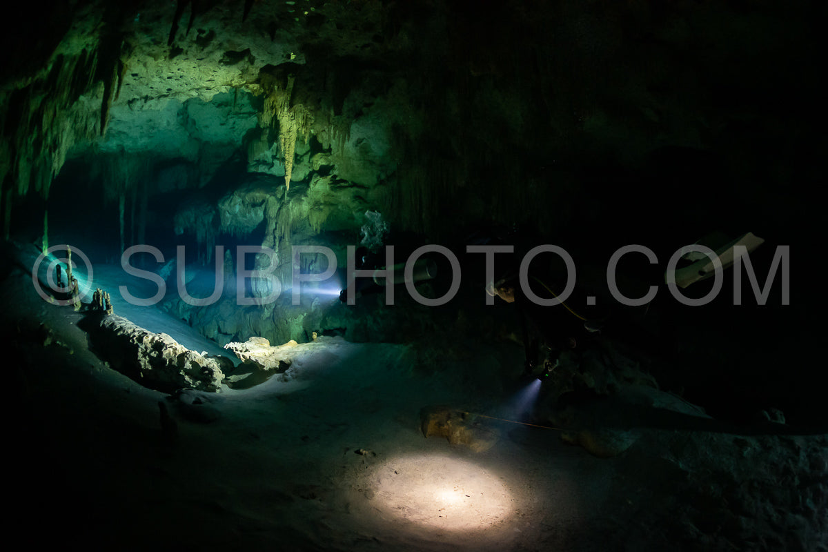 Photo de instructeur de plongée spéléo dirigeant un groupe de plongeurs dans un cenote mexicain sous l'eau