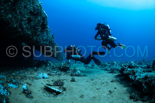 Two divers are exploring a wreck the Red Sea. They are using rebreathers- which allow them to stay underwater for longer periods of time.