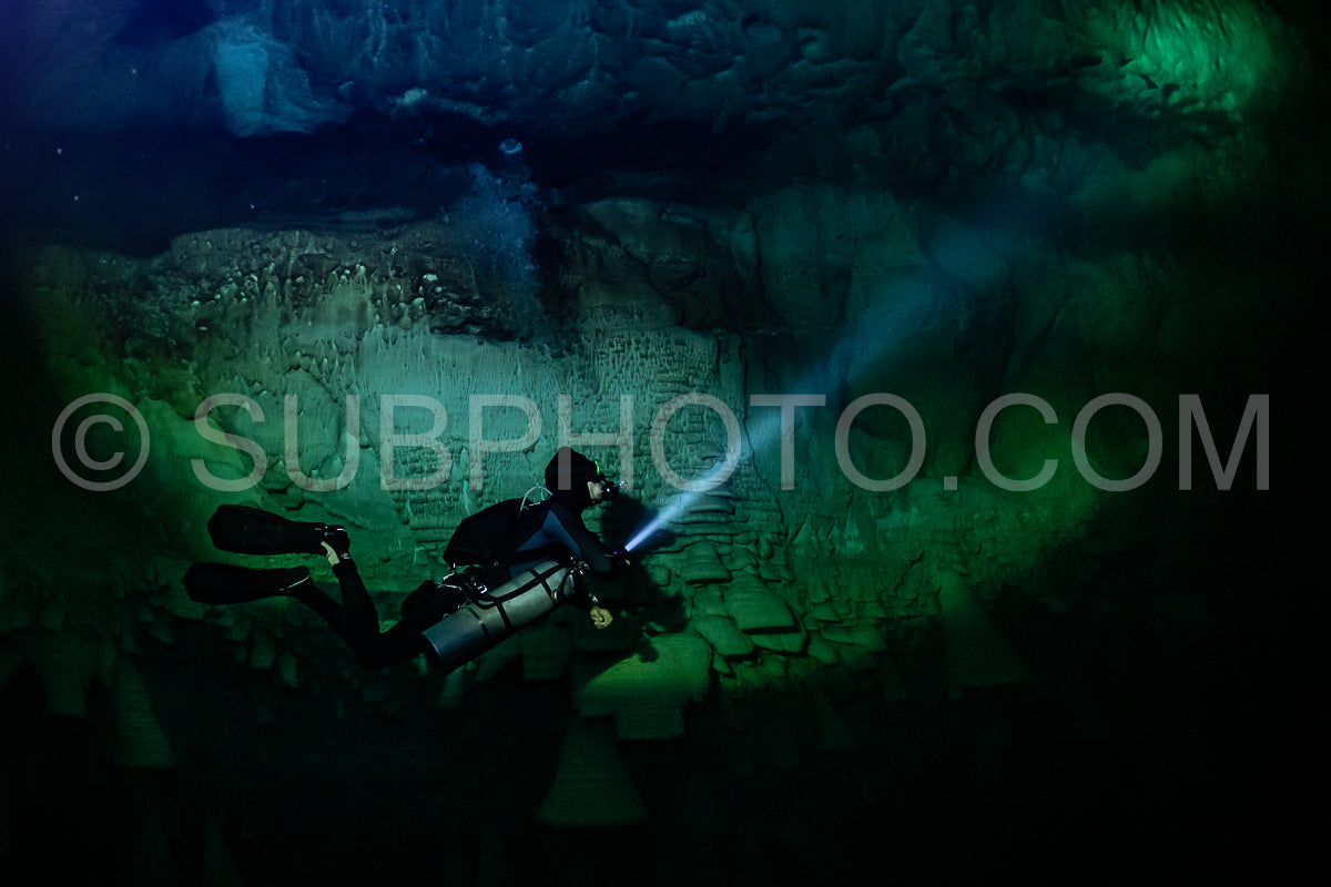 cave diver instructor leading a group of divers in a mexican cenote underwater